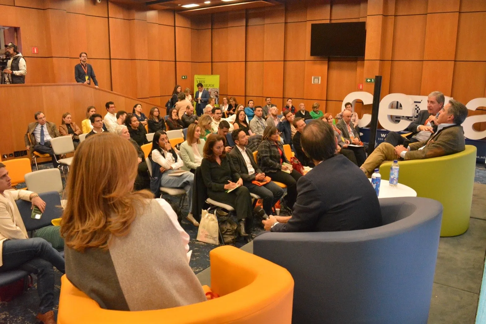 Auditorio lleno durante una jornada del Congreso de Líderes, con el panel sobre la tarima y el equipo de cámara cubriendo la sesión